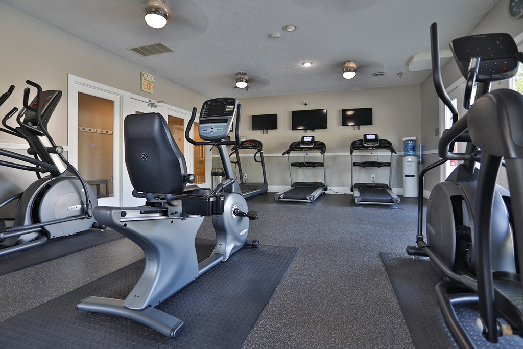 a gym with treadmills and other exercise equipment