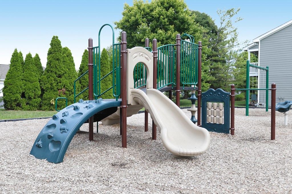 a playground with a slide and climbing equipment