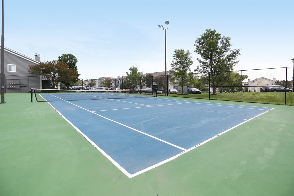 the tennis court at the whispering winds apartments in pearland tx
