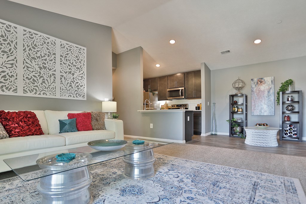 a living room with a white couch and a glass table