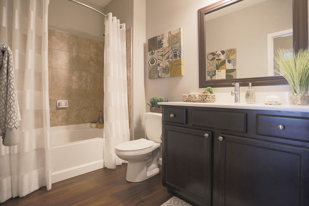 a bathroom with a toilet and a sink and a bath tub