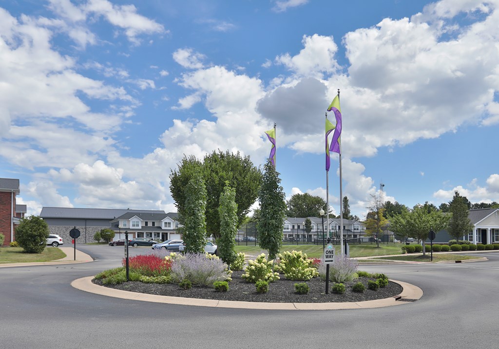 A roundabout with a purple flag on top of a pole.