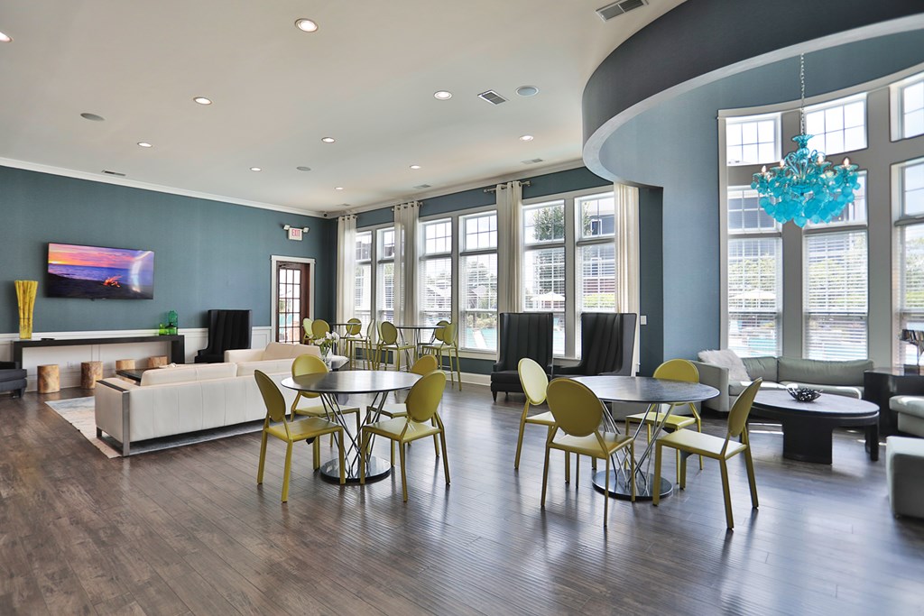 A modern dining room with a large table and chairs.