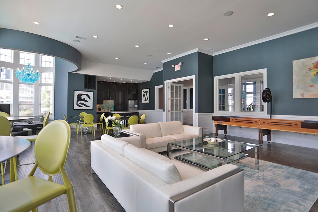 A modern living room with a white sofa and yellow chairs.