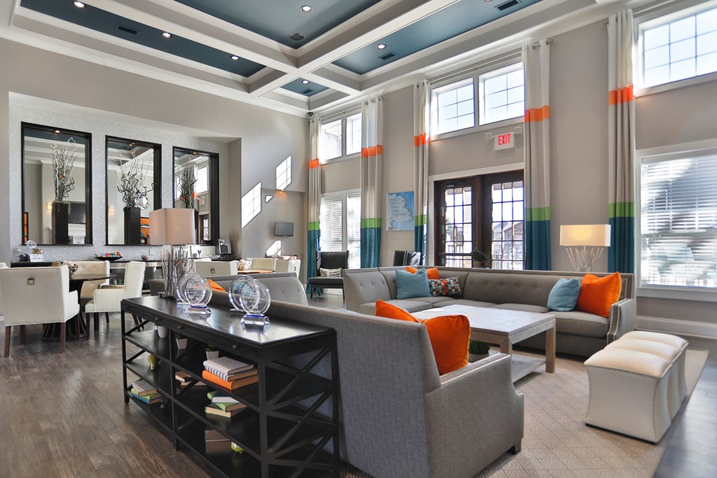 a living room with couches and chairs and a table