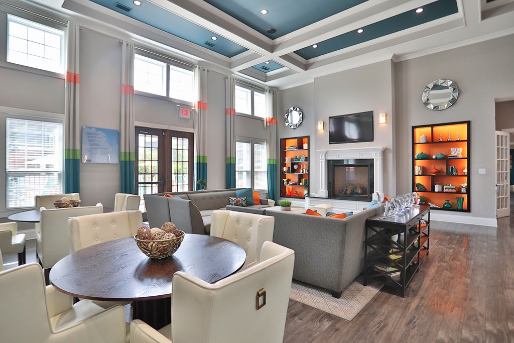 A modern dining room with a wooden table and white chairs.