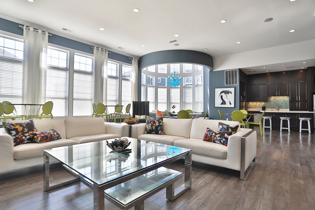 a living room with couches and a glass table