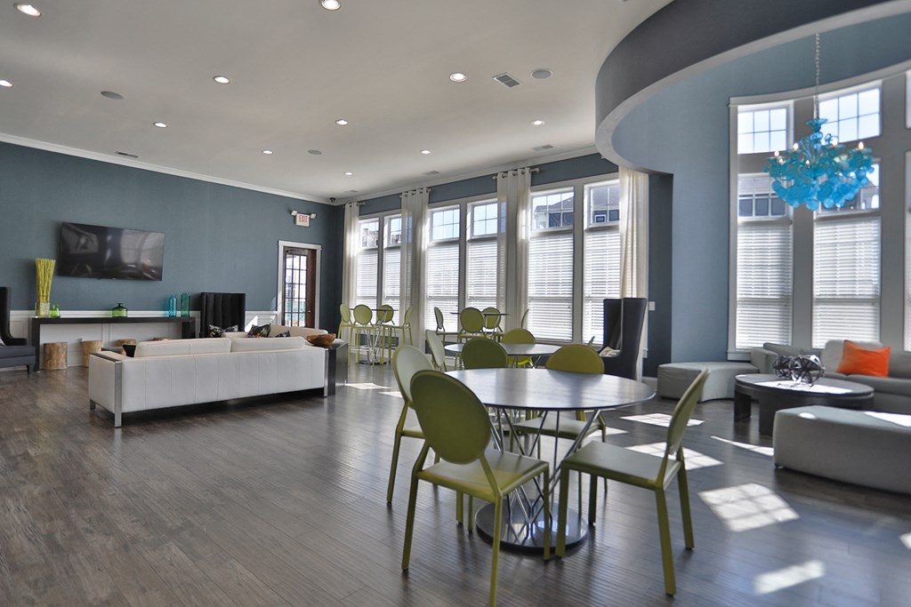 a living room with a round table and chairs and a couch