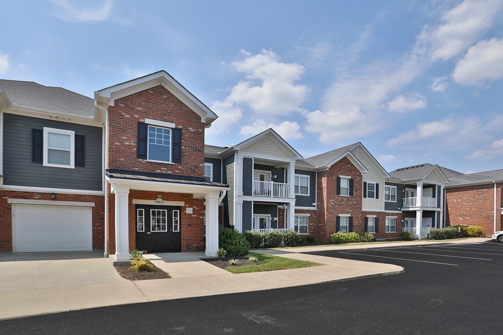 a row of brick and white houses on a street