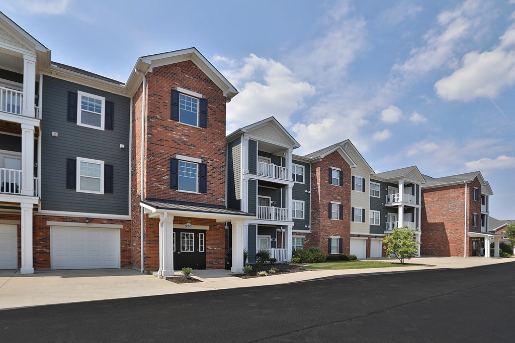 a row of town houses with a street in front of them