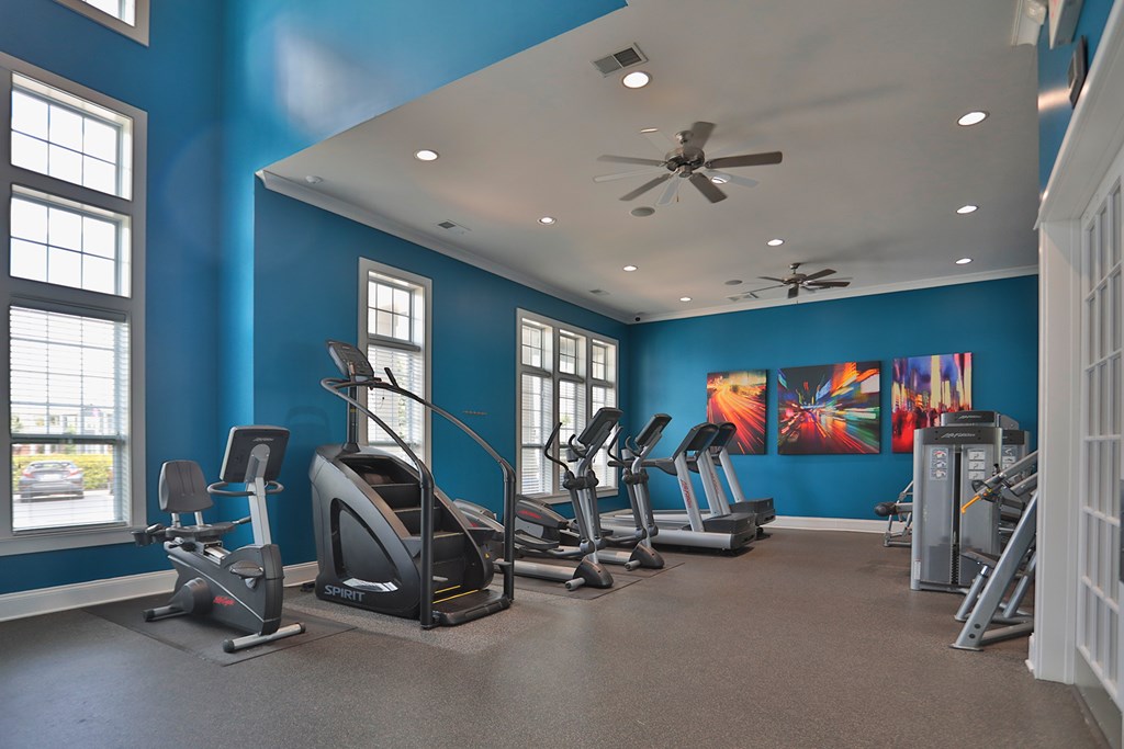 A gym with a variety of exercise equipment.