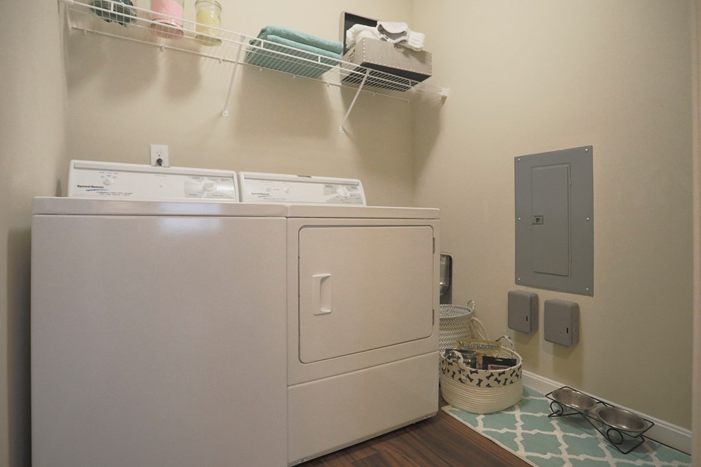 a laundry room with a washer and dryer and a door