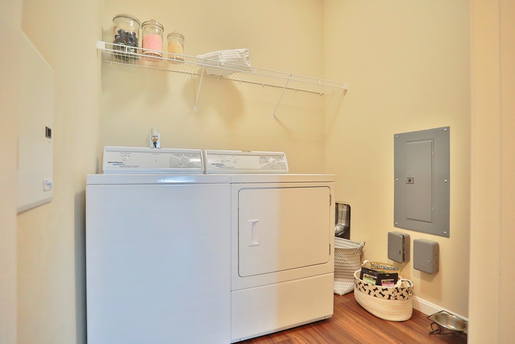 A small laundry room with a washer and dryer.