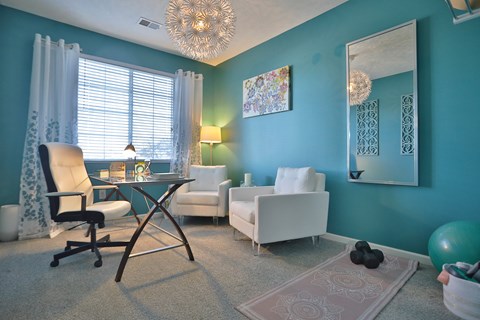 A room with a blue wall and a white chair.