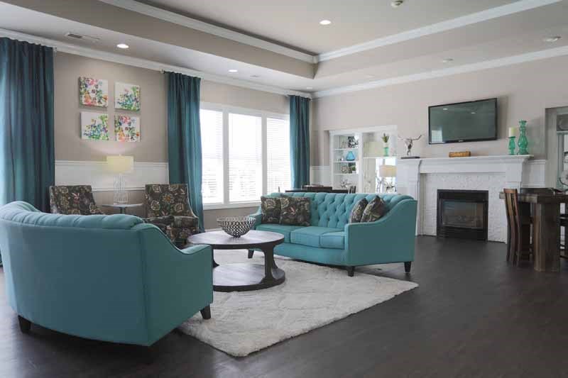 a living room with blue furniture and a fireplace