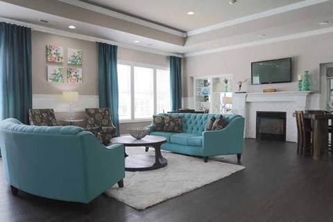 a living room with blue furniture and a fireplace