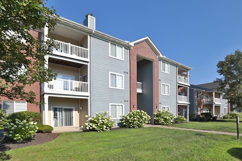 Apartment building with a green lawn in front.