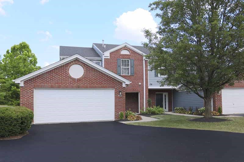 a red brick house with a white garage door