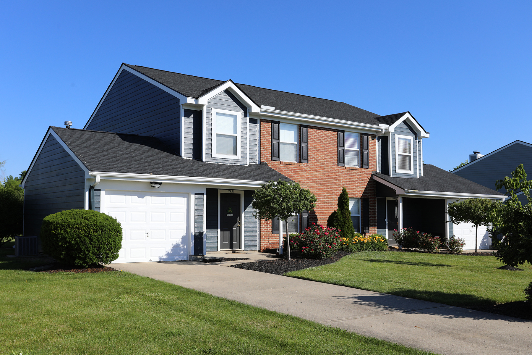a house with a white garage door in front of it