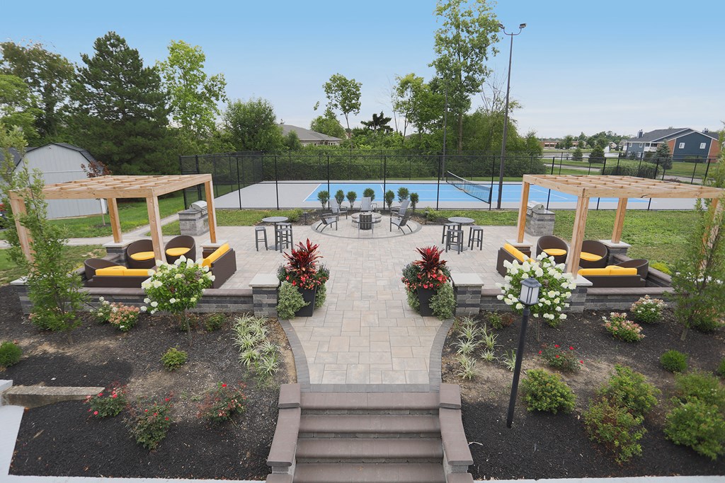 an aerial view of an outdoor area with a pool and patio furniture