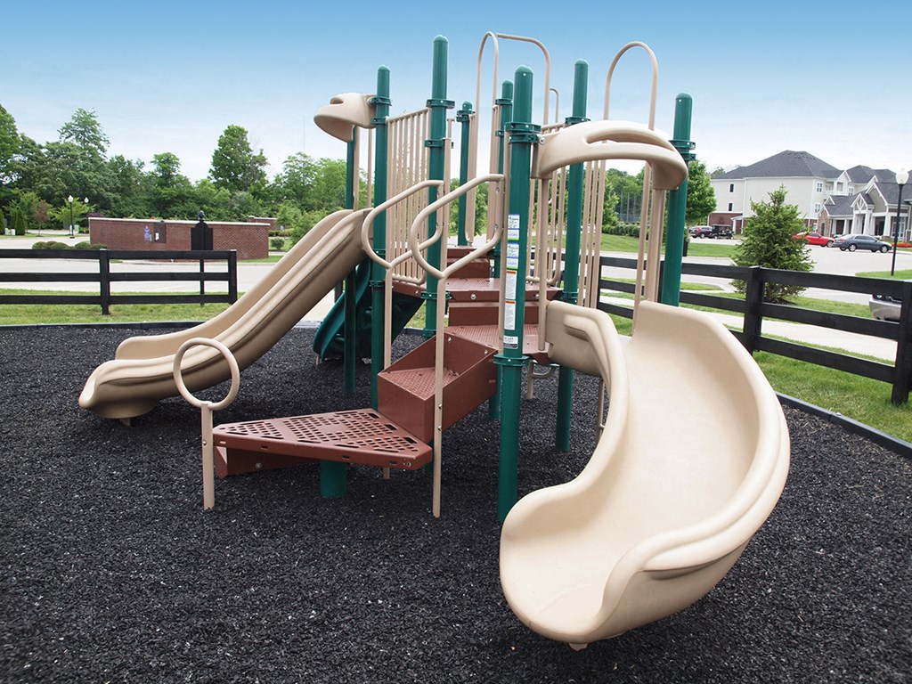 a playground with slides and climbing equipment in a park