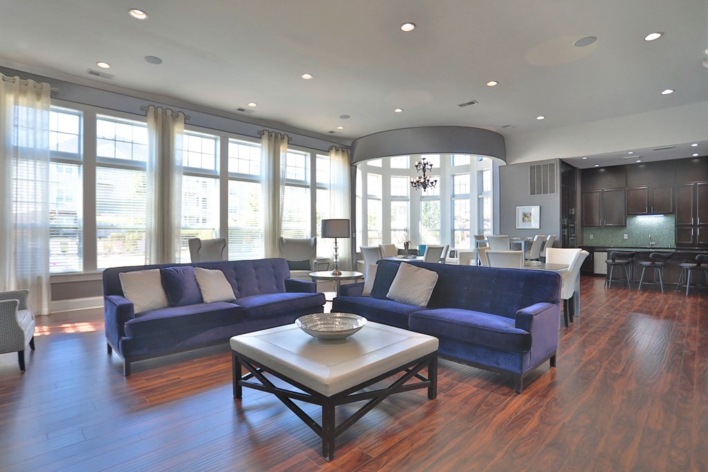 A living room with a blue couch and a coffee table.