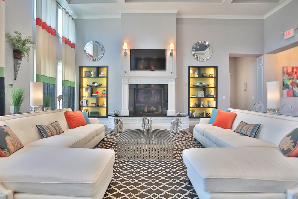 A living room with a fireplace and two couches.