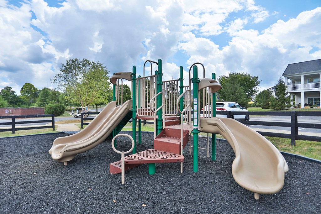 A playground with a slide and a climbing frame.