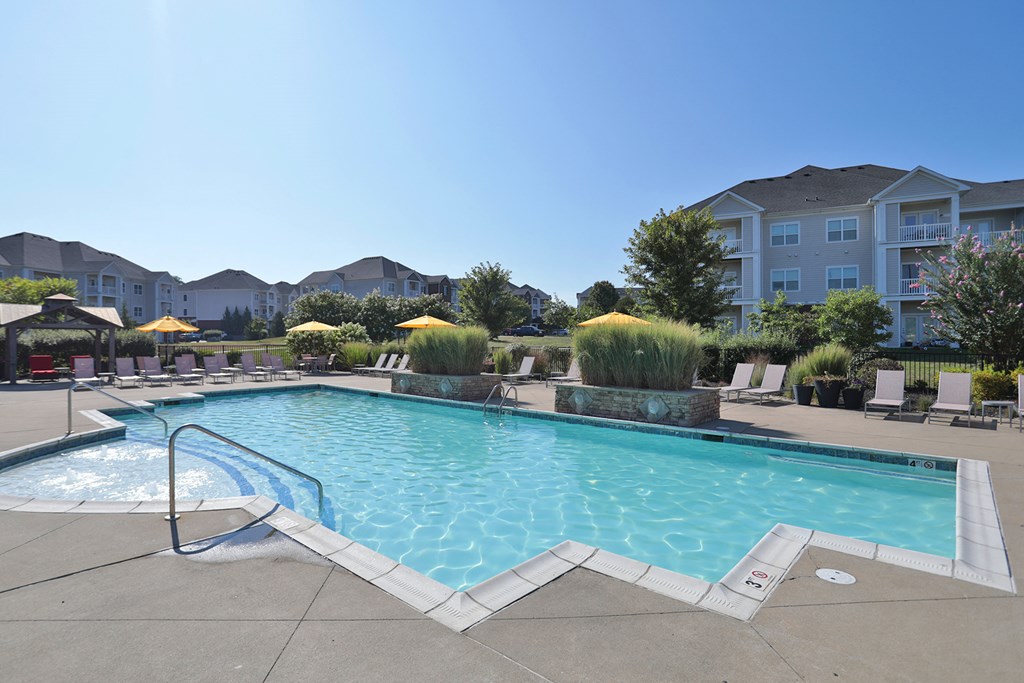 A large swimming pool with a slide in the middle of it.