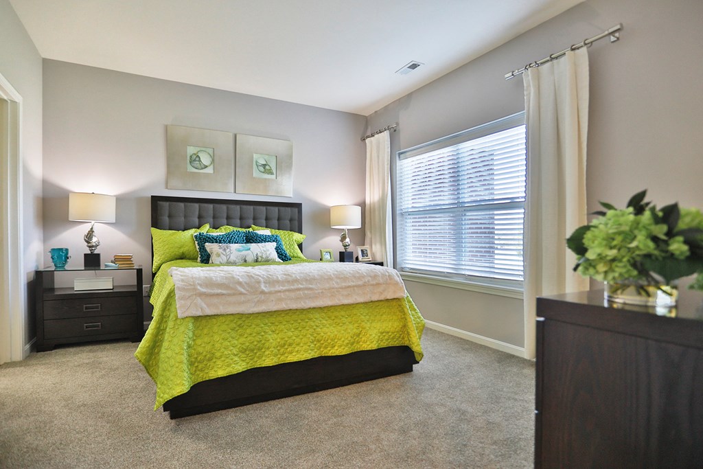 a bedroom with a yellow bed and a window