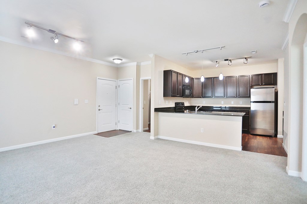 A spacious kitchen with a white countertop and stainless steel appliances.