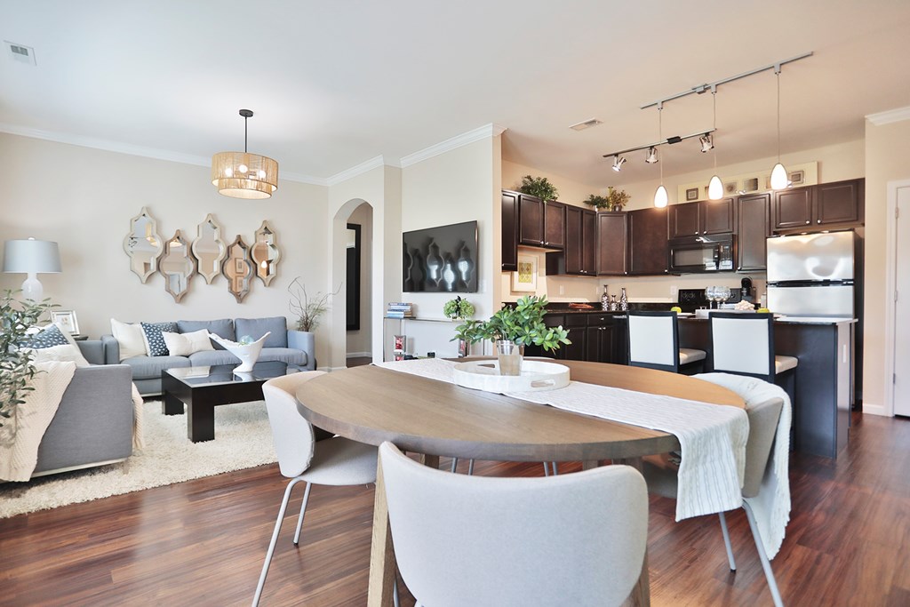 A modern dining room with a wooden table and chairs.