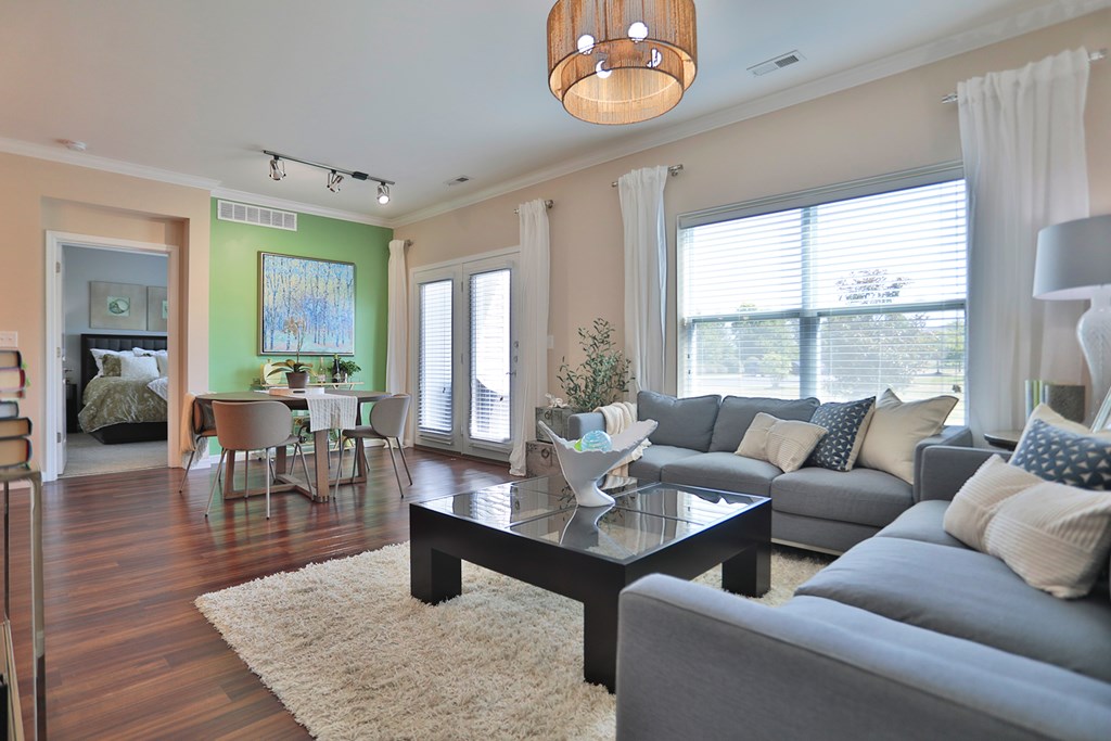 A living room with a grey couch and a coffee table.