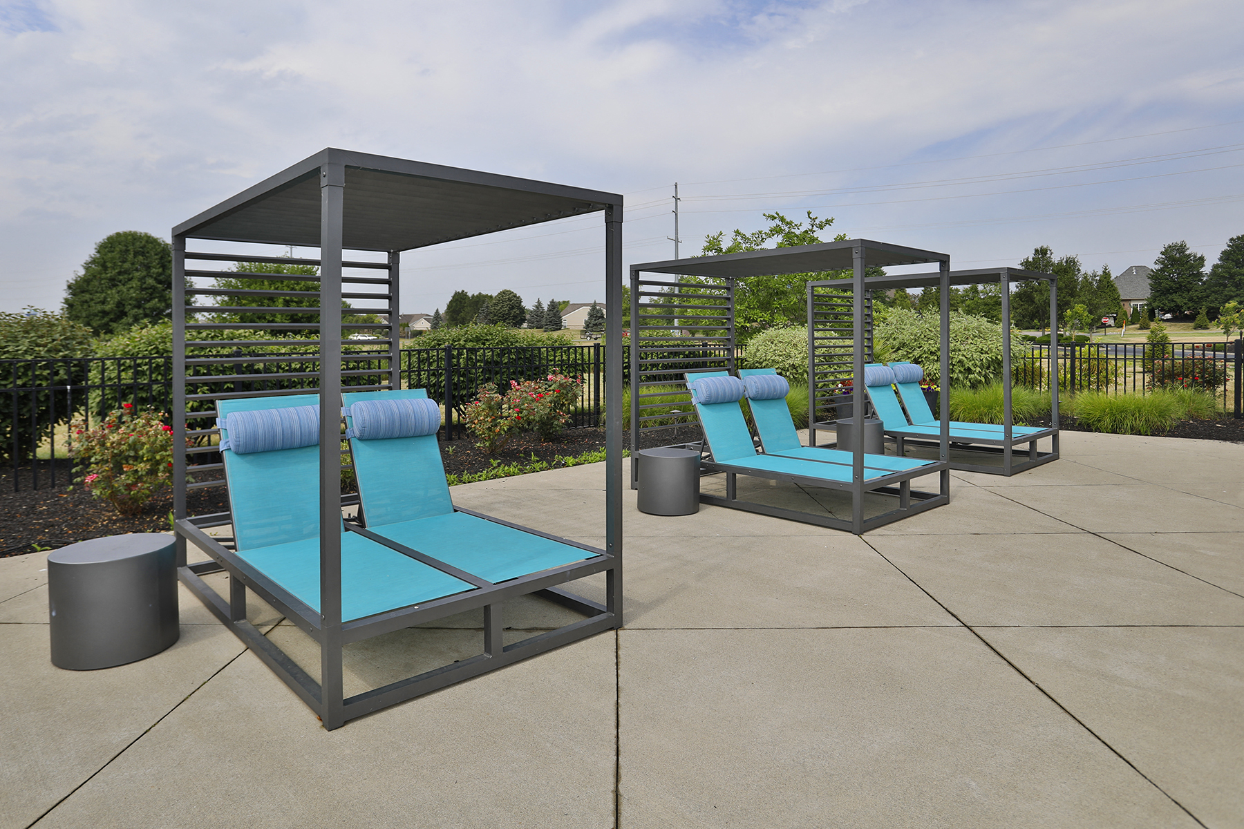 a group of blue lounge chairs sitting under a canopy
