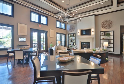 A modern dining room with a large table and chairs.