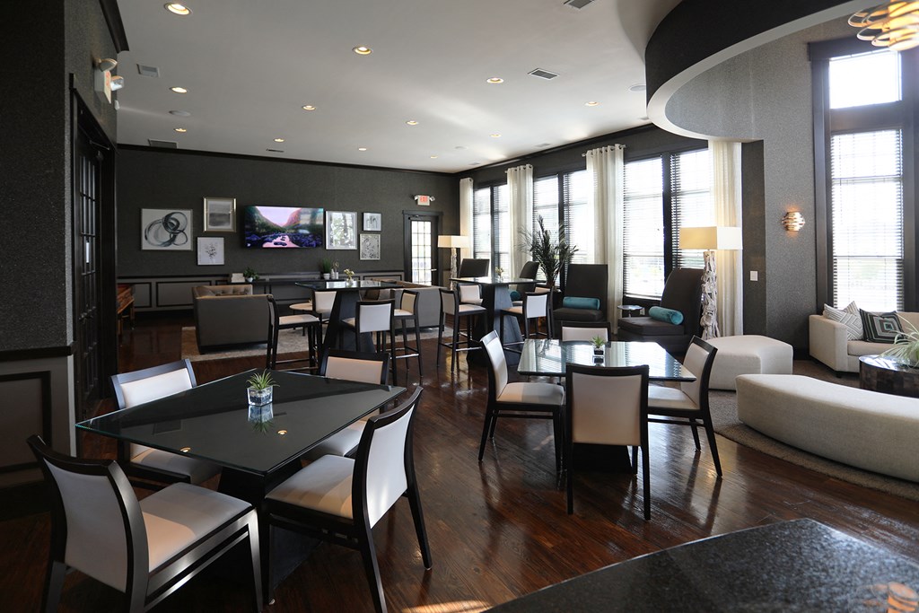 a restaurant and lounge area of a hotel with tables and chairs