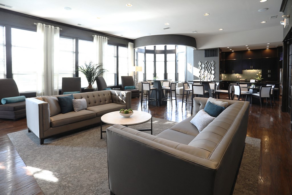 a large living room with couches and chairs and a table