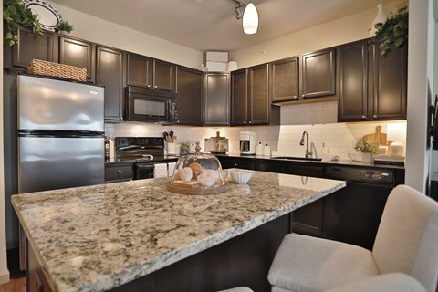 a kitchen with stainless steel appliances and granite counter tops