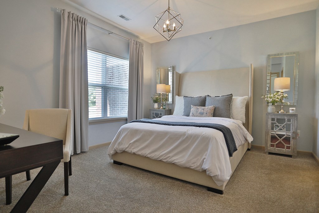 a bedroom with a bed and a table and chairs