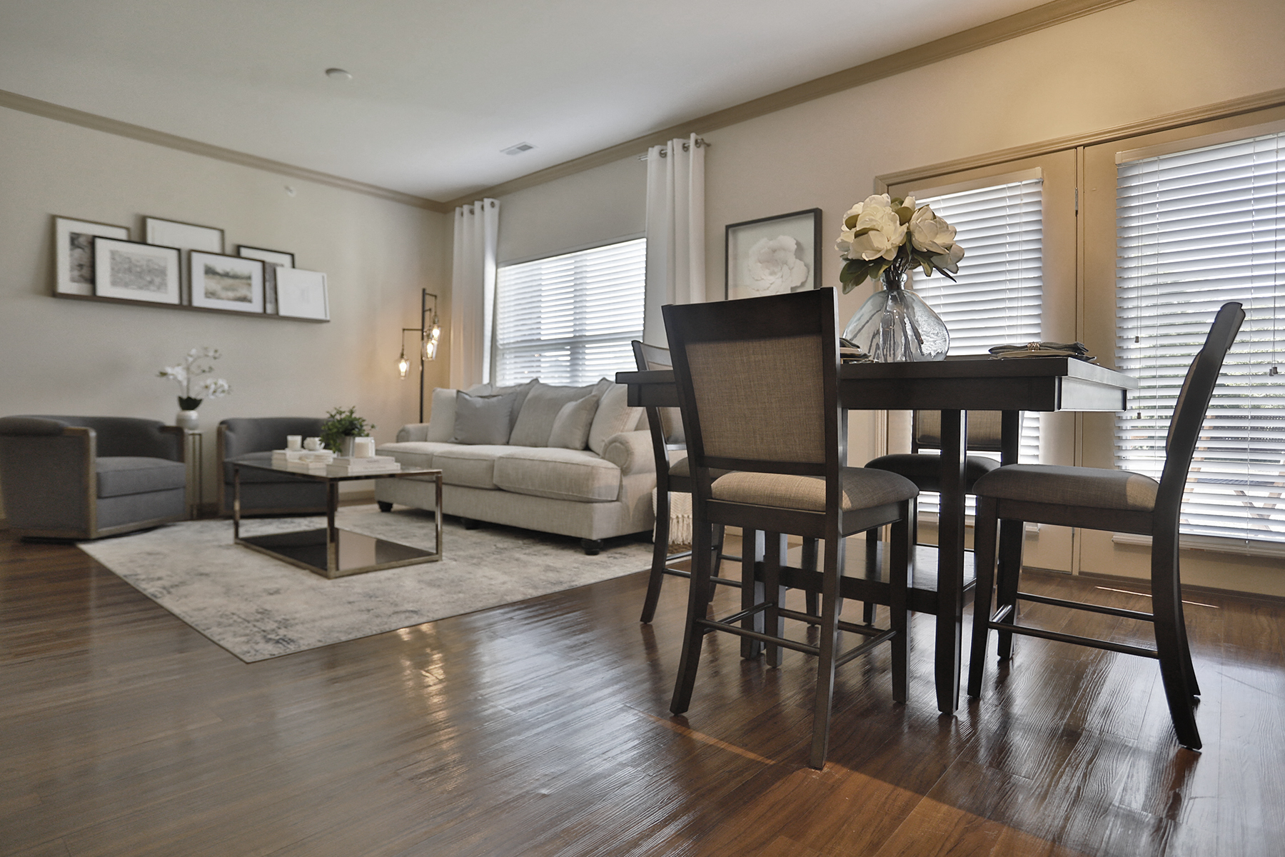 a living room and dining room with a table and chairs