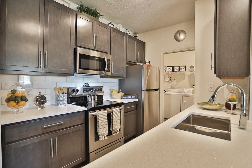 a kitchen with stainless steel appliances and granite counter tops
