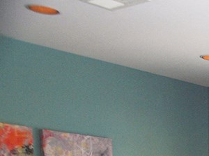 a dining room with blue walls and a table and chairs