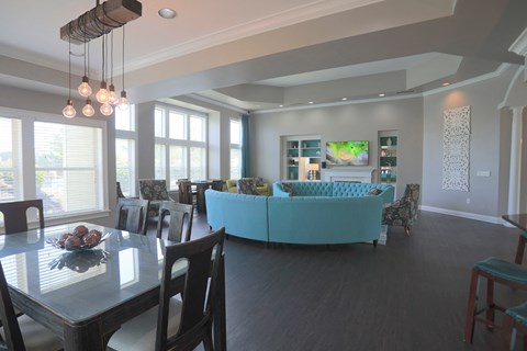 A modern dining room with a glass table and chairs.