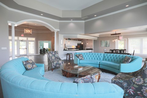 A living room with a blue couch and a coffee table.