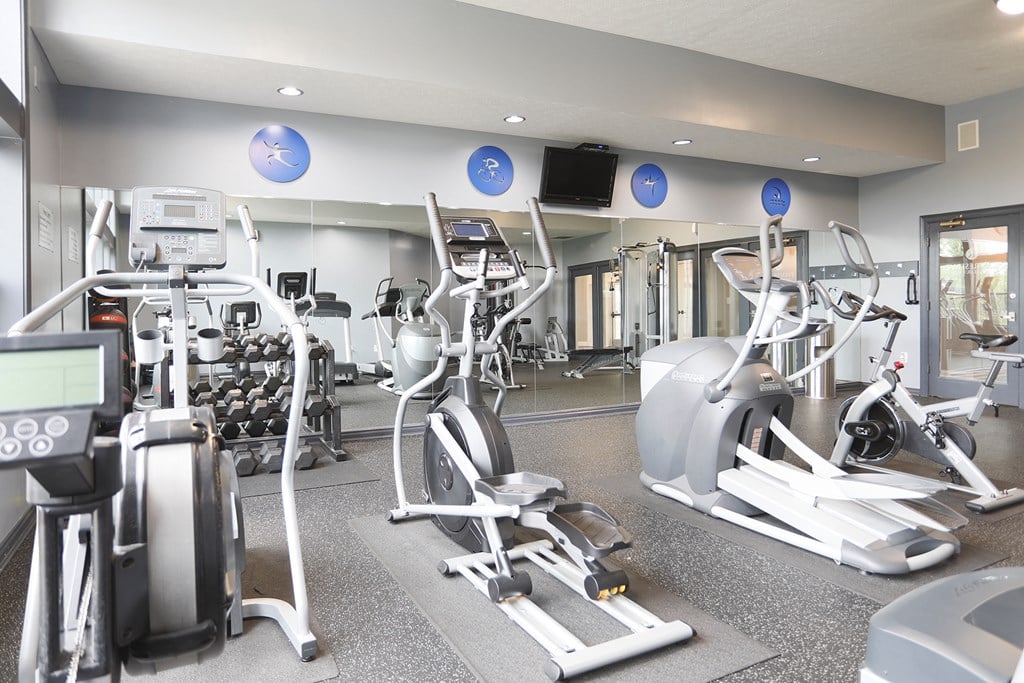 a gym with cardio machines and weights at the renaissance valencia resort and spa