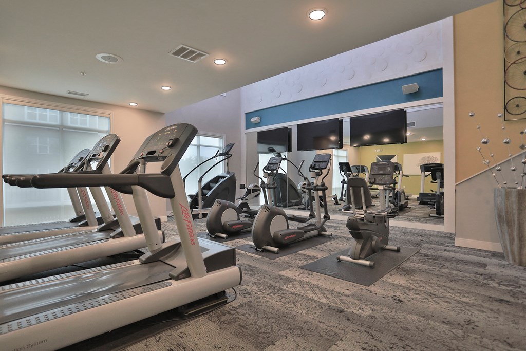 a gym with treadmills and other exercise equipment in a building