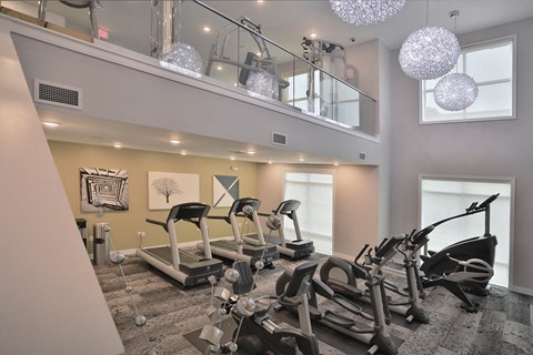 a gym with treadmills and other exercise equipment