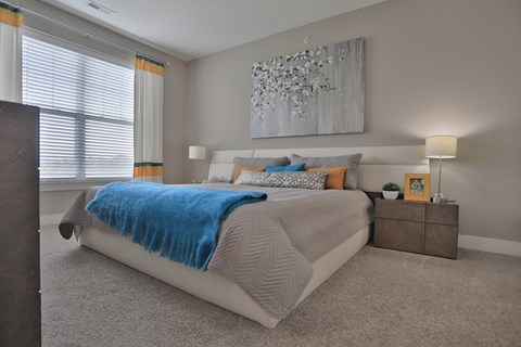 a bedroom with a white bed and a blue blanket