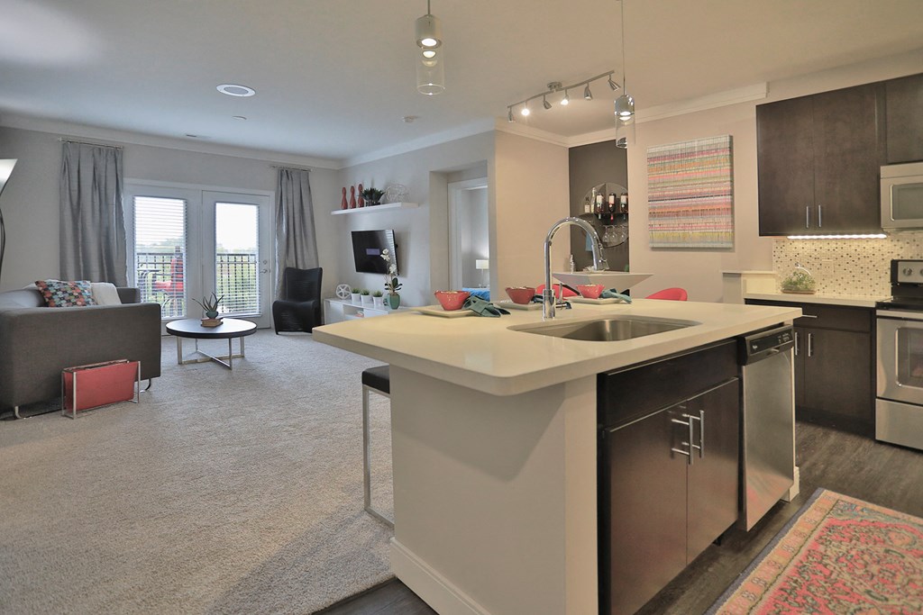 a kitchen with a large island in the middle of a living room