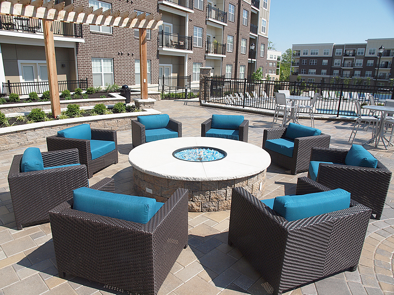 an outdoor patio area with chairs and a fire pit